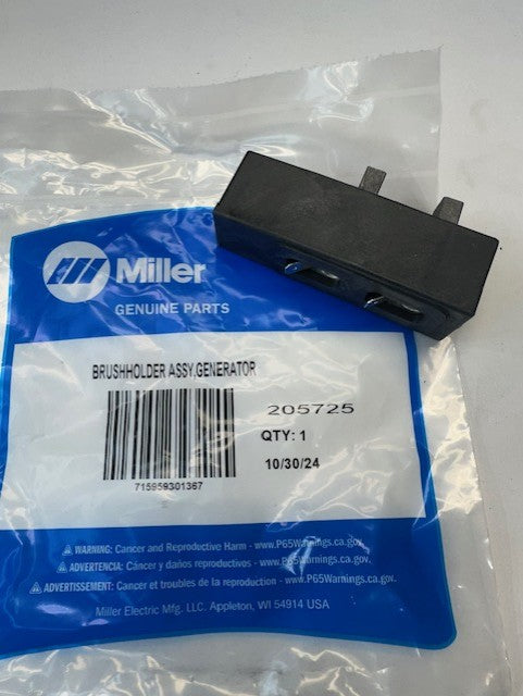 A brushholder assembly for a generator & Bobcat 225, part of the Miller brand, packaged in a blue and white bag with the product visible on top.